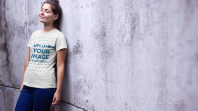 T-Shirt Video of a Relaxed Woman Leaning on a Concrete Wall