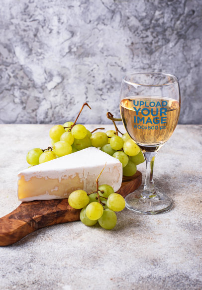 Mockup of a Wine Glass Next to a Piece of Cheese 36550-r-el2