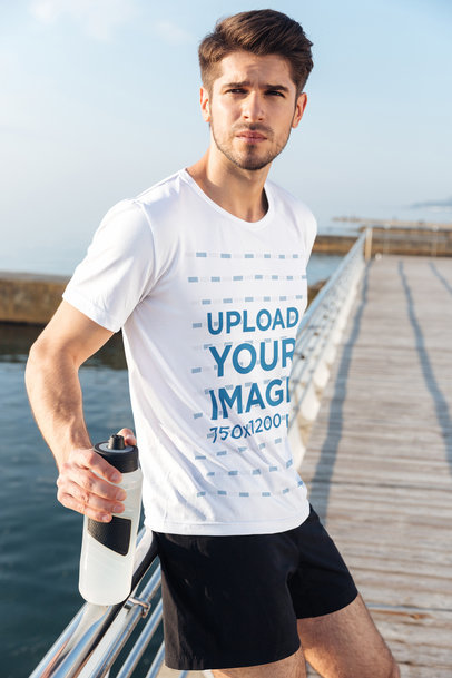 Activewear T-Shirt Mockup of a Man Leaning on a Handrail by the Beach 34519-r-el2