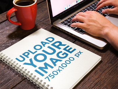 Spiral School Notebook Mockup Lying Near Laptop Being Used and a Coffee Mug